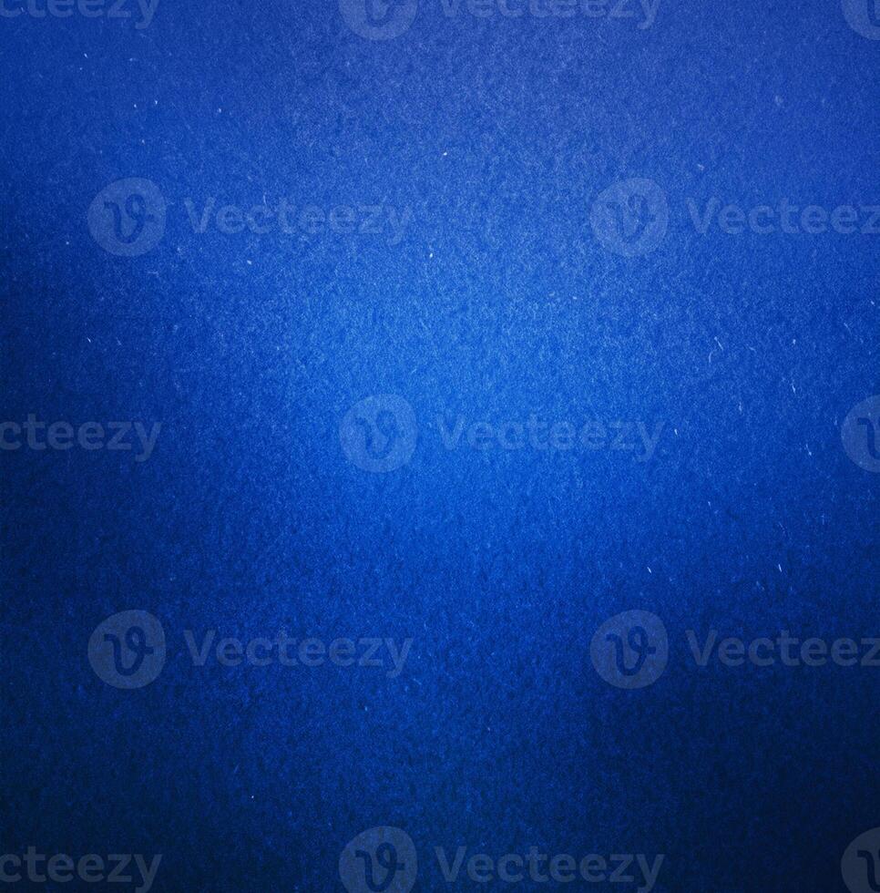 Abstract close-up of a blue textured background featuring a smooth gradient effect and subtle surface details. photo