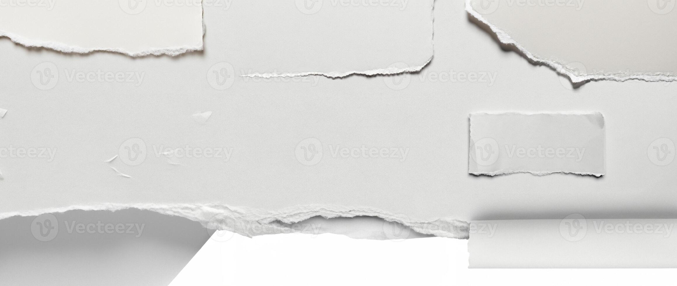 Close-up of a torn edge of white paper with rough texture, isolated on a clean white background. photo