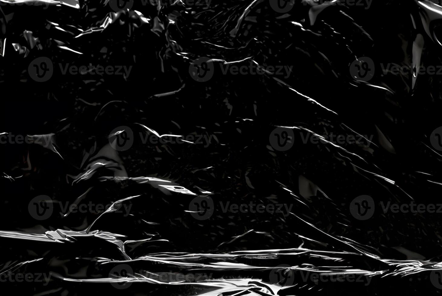 Dark abstract texture with glossy, reflective surfaces creating sharp highlights and flowing lines. photo