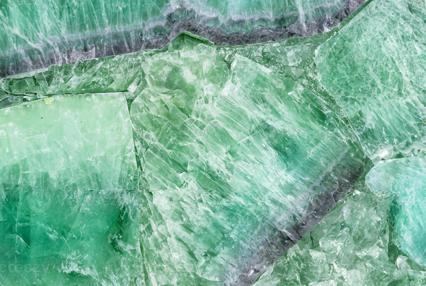Close-up of green crystal stone texture, ideal for natural patterns, backgrounds, or decorative elements. photo