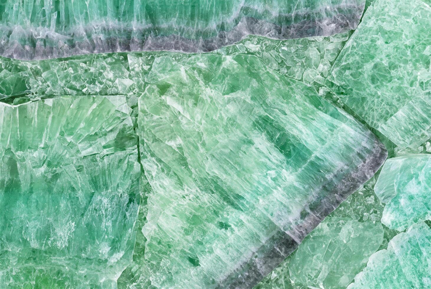 Close-up of green crystal stone texture, ideal for natural patterns, backgrounds, or decorative elements. photo