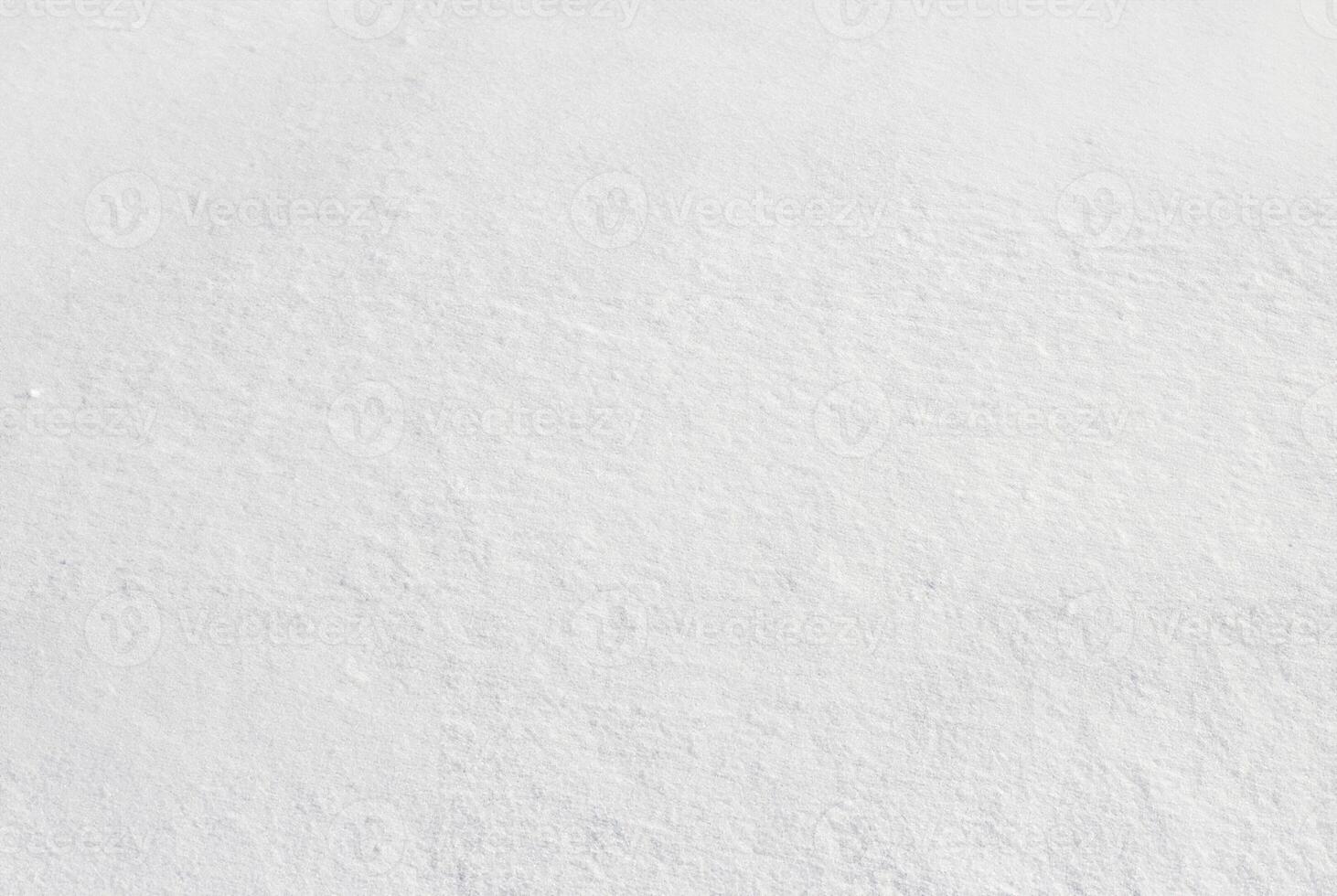 Closeup of fresh, untouched snow surface with natural soft textures, ideal for backgrounds or winter-themed designs. photo