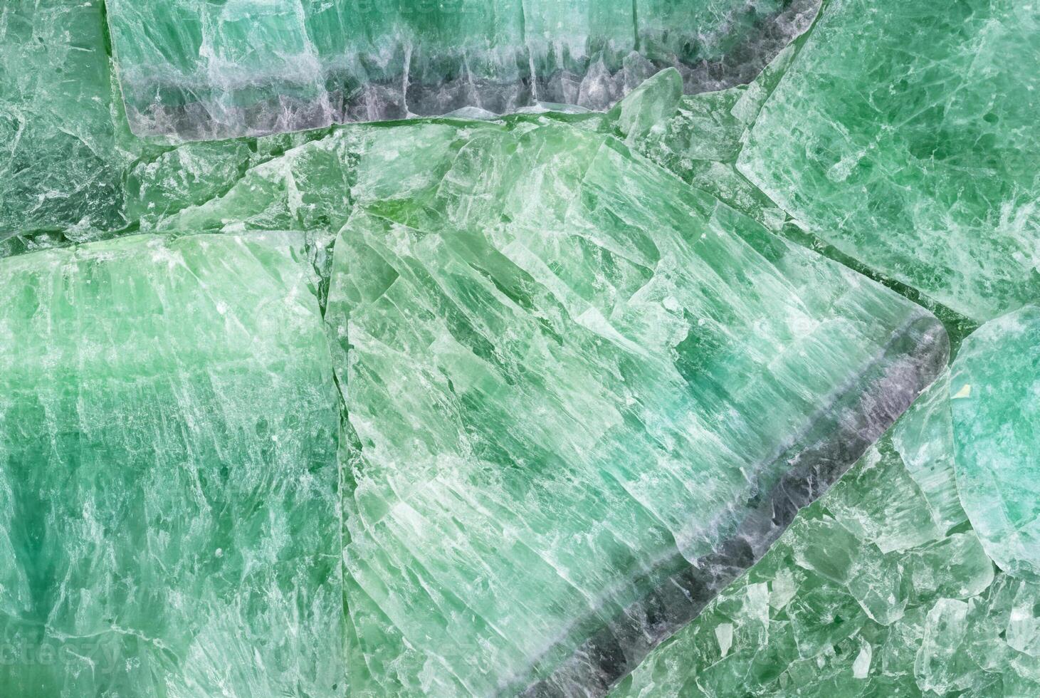 Close-up of green crystal stone texture, ideal for natural patterns, backgrounds, or decorative elements. photo