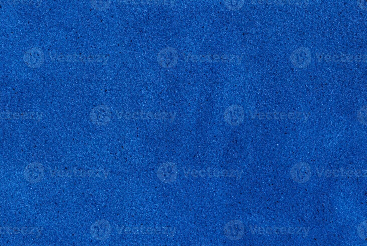 Bright blue textured surface, ideal as a background or design element for creative and decorative projects. photo