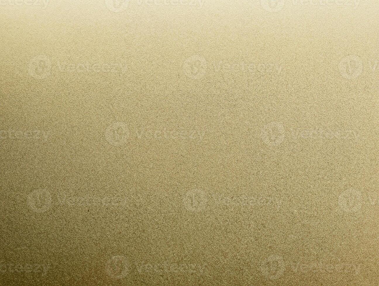 Close-up of golden sandpaper texture with a fine, grainy surface, perfect for backgrounds and design elements. photo