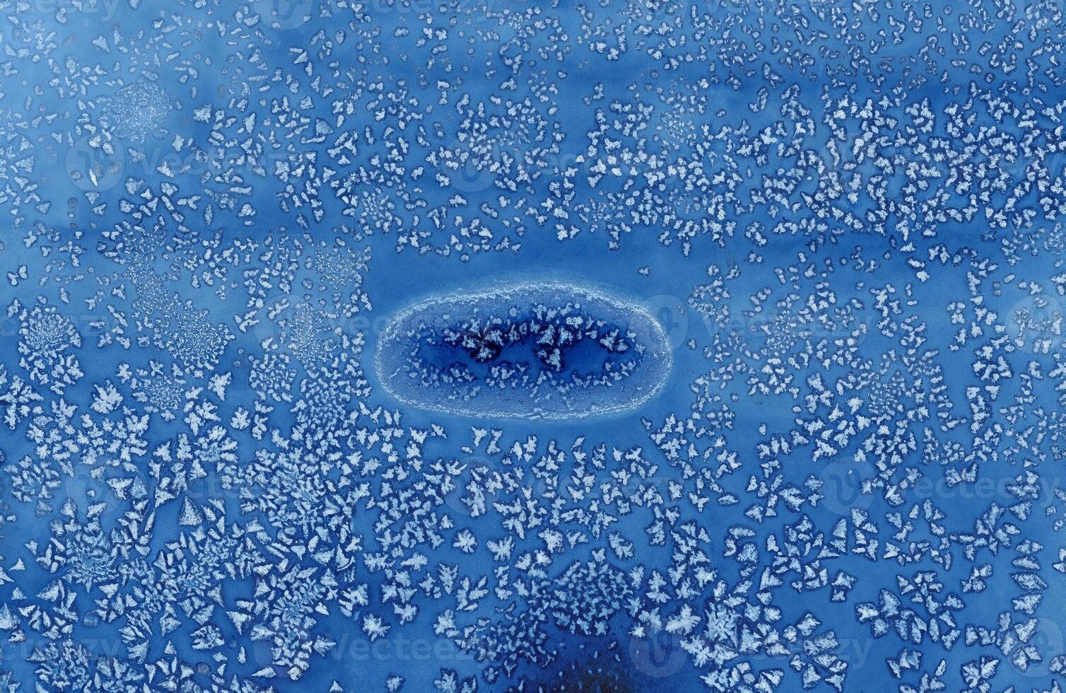 Abstract blue frost pattern resembling ice crystals, perfect for winter-themed designs, backgrounds, and creative projects. photo