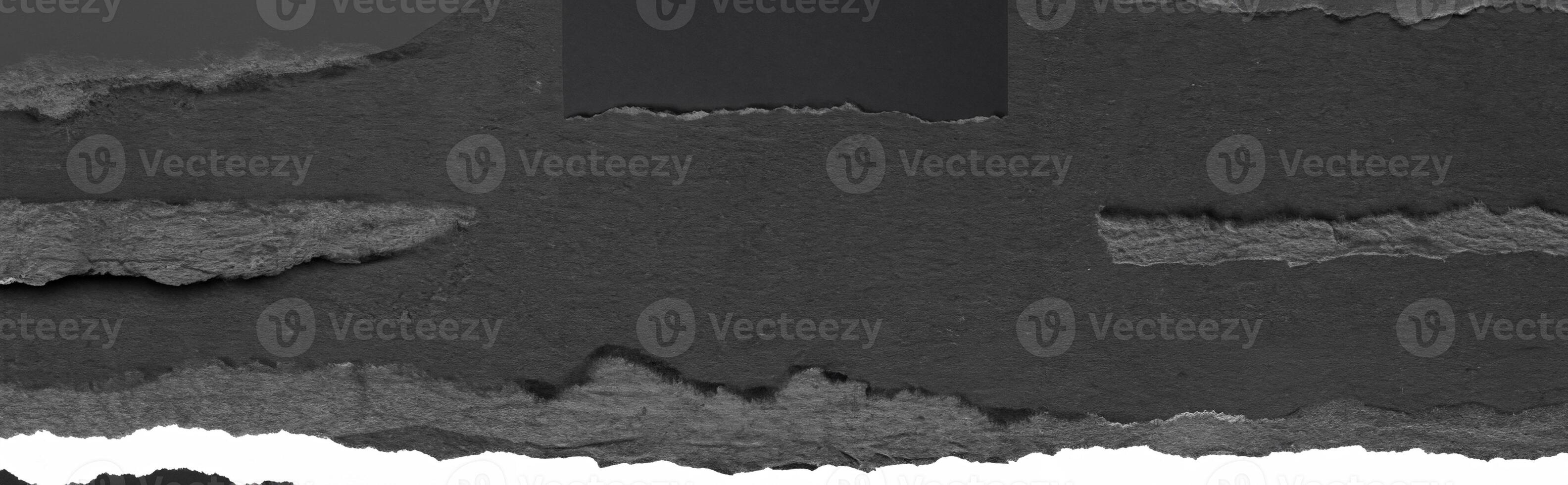 Close-up texture of torn black paper with a rough edge, perfect for background, design, or collage elements. photo