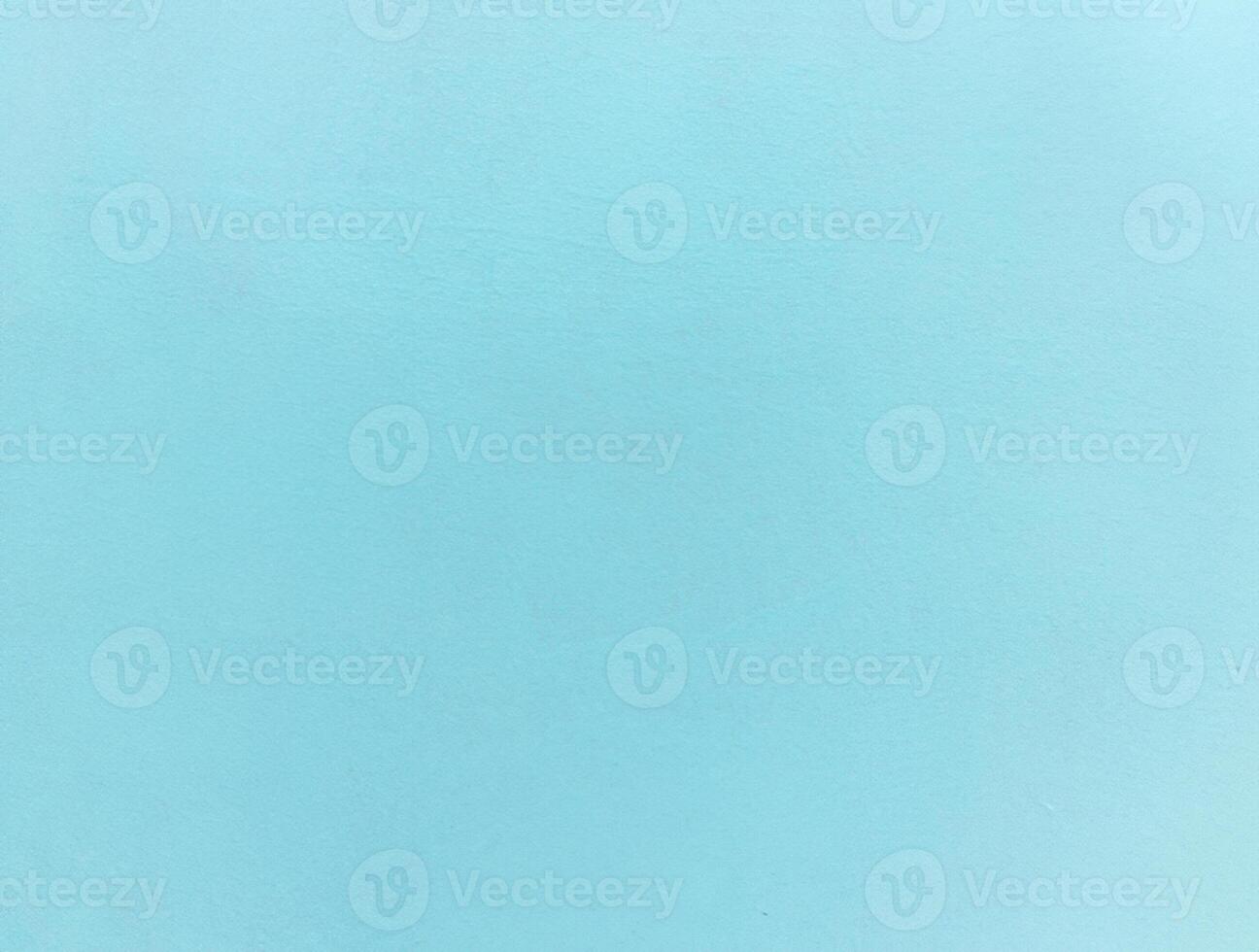 Minimalist light blue textured background with a subtle grain, ideal for design projects or as a backdrop. photo