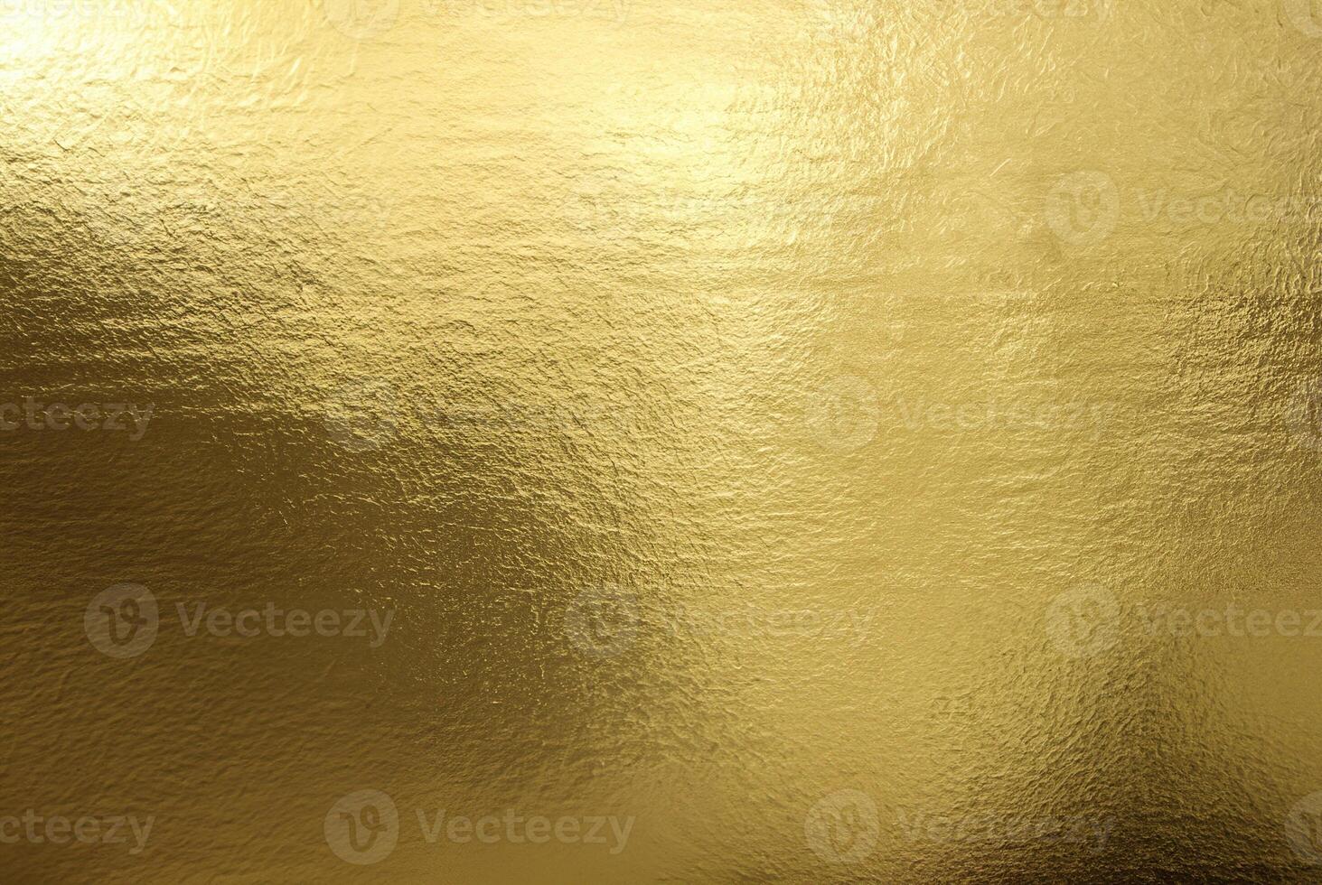 Shiny gold foil texture with a smooth, reflective surface ideal for backgrounds or luxurious designs. photo