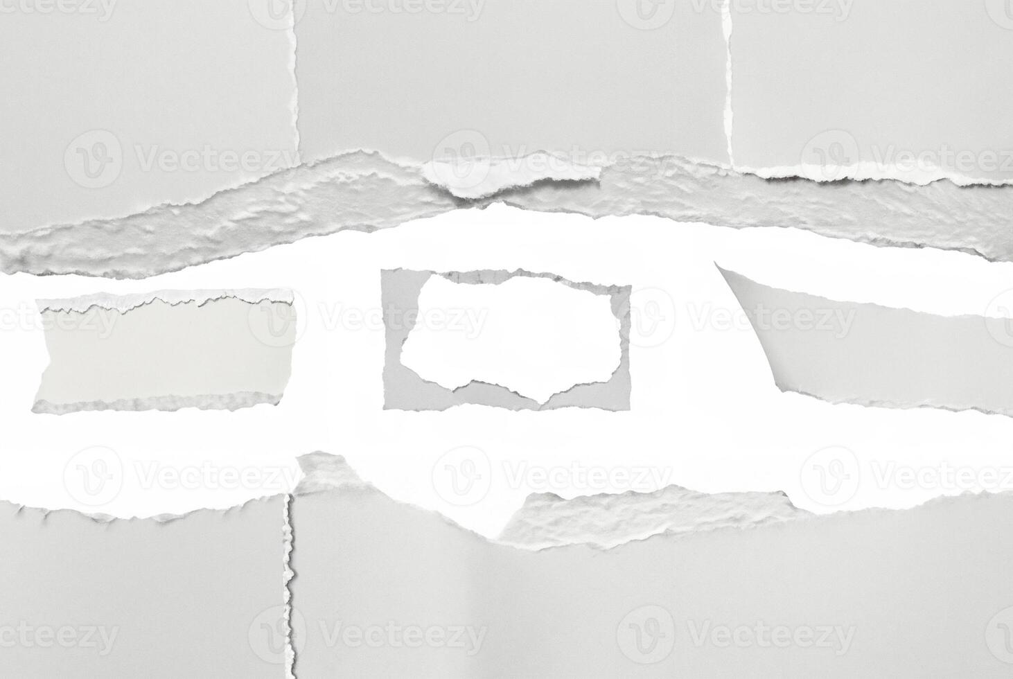 A close-up of torn paper with rough ripped edges, creating a blank white space in the center. Ideal for text insertion or creative design projects. photo