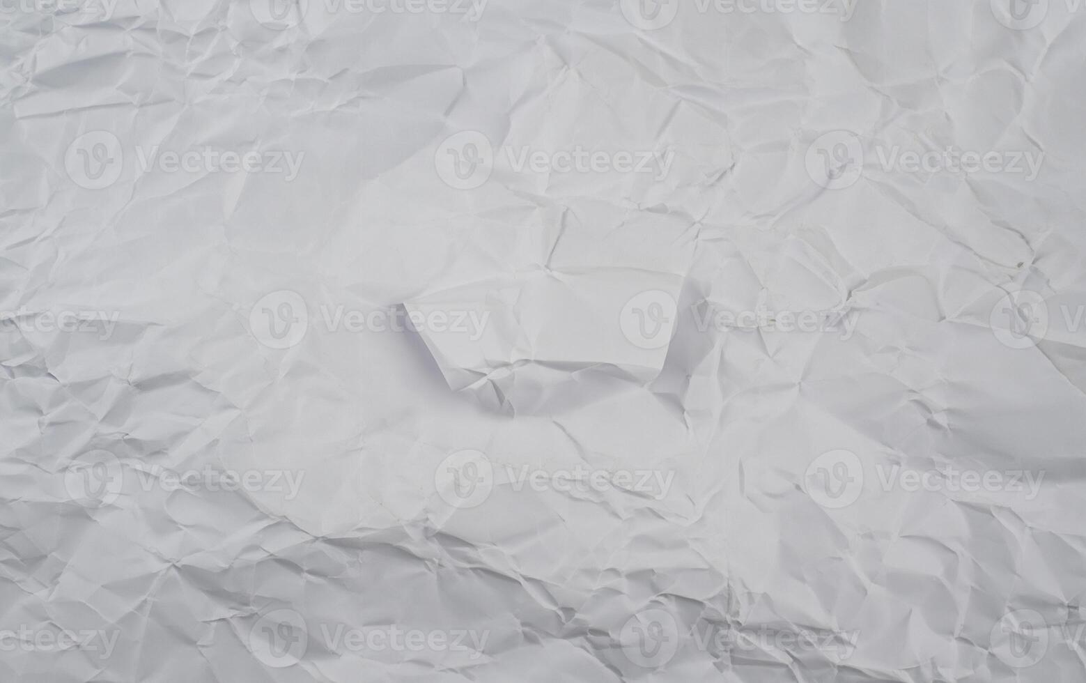 Crumpled white paper background with visible folds and creases, perfect for use in textures or design elements. photo