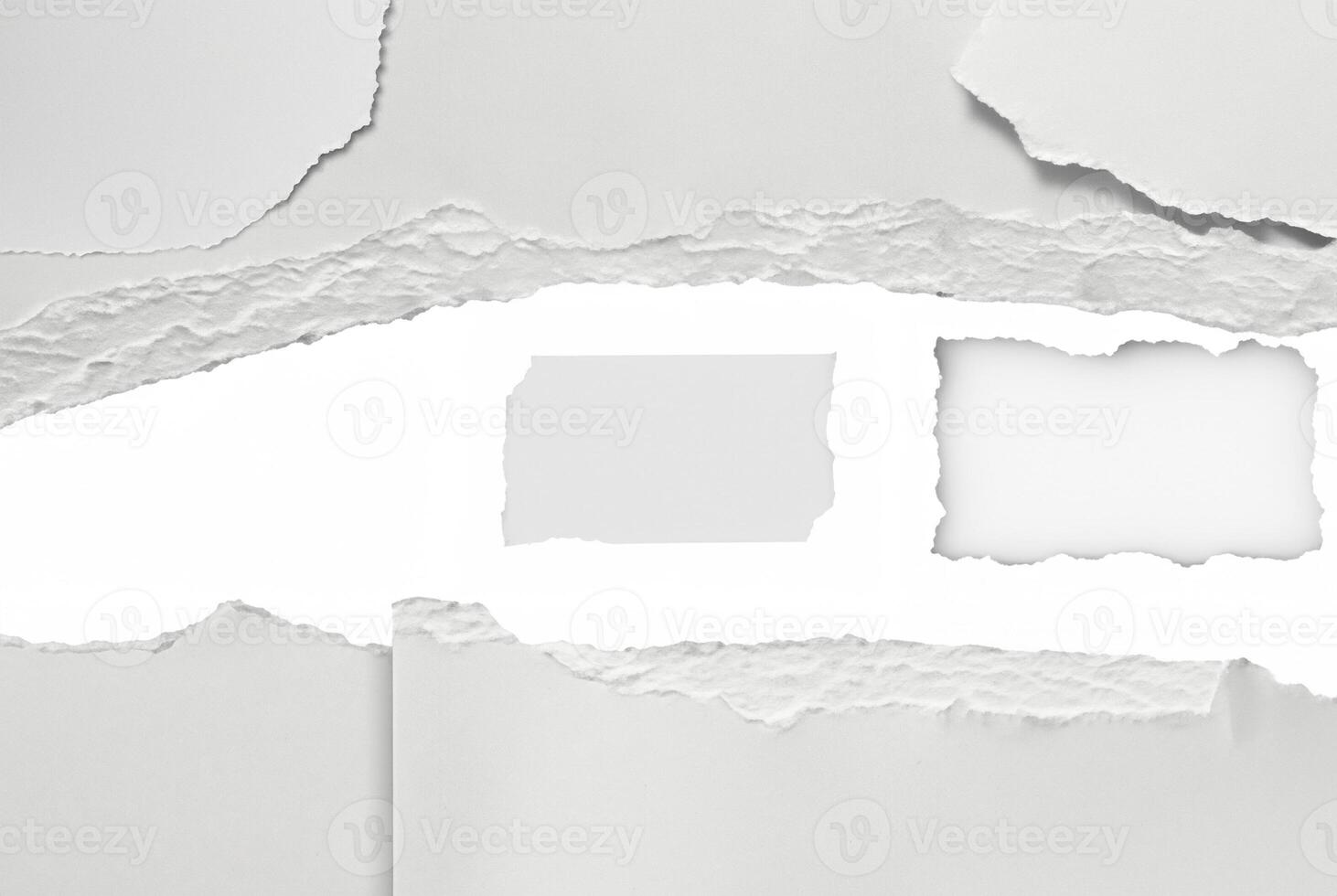 A close-up of torn paper with rough ripped edges, creating a blank white space in the center. Ideal for text insertion or creative design projects. photo