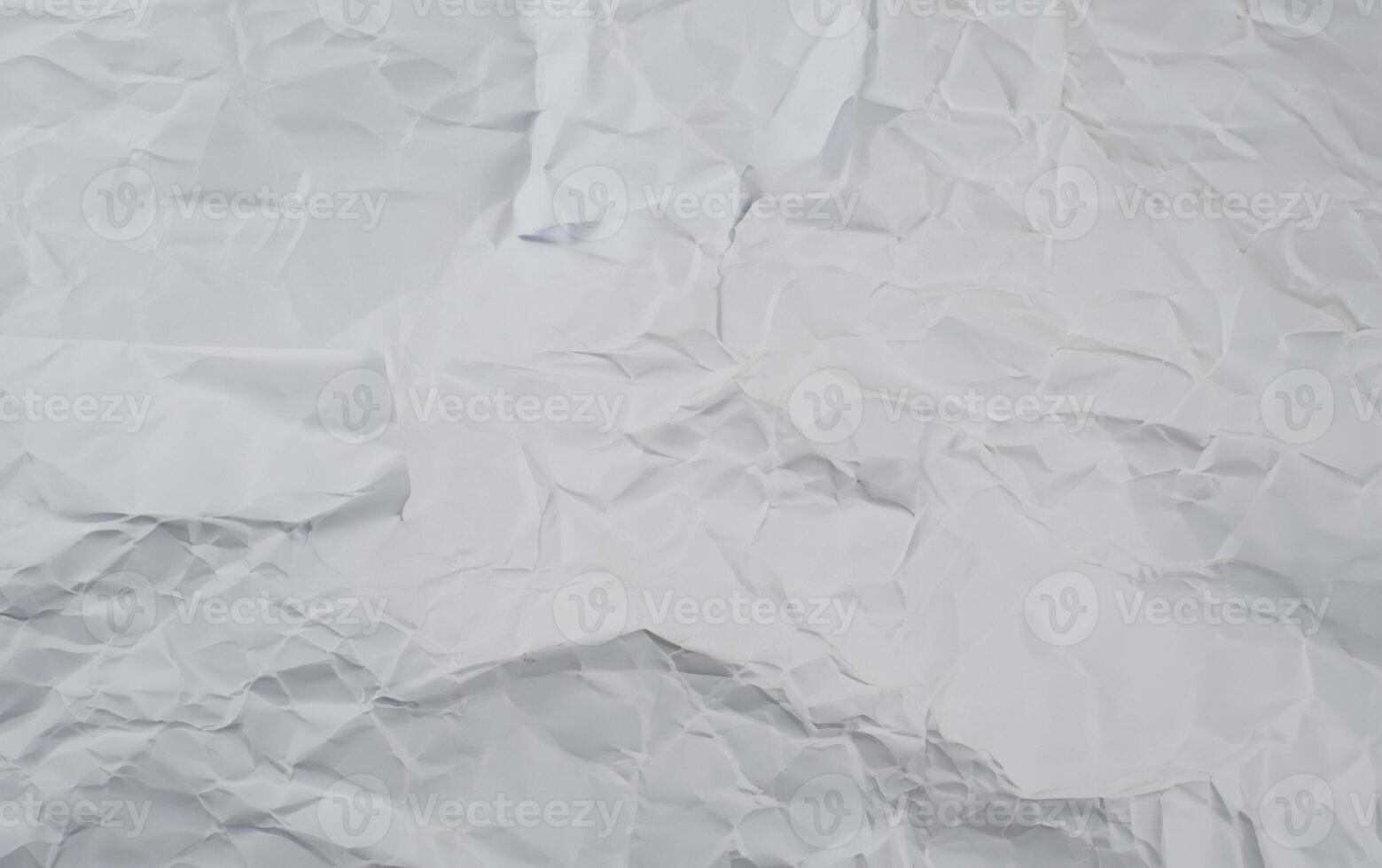 Crumpled white paper background with visible folds and creases, perfect for use in textures or design elements. photo