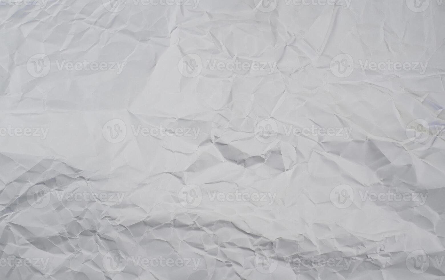 Crumpled white paper background with visible folds and creases, perfect for use in textures or design elements. photo