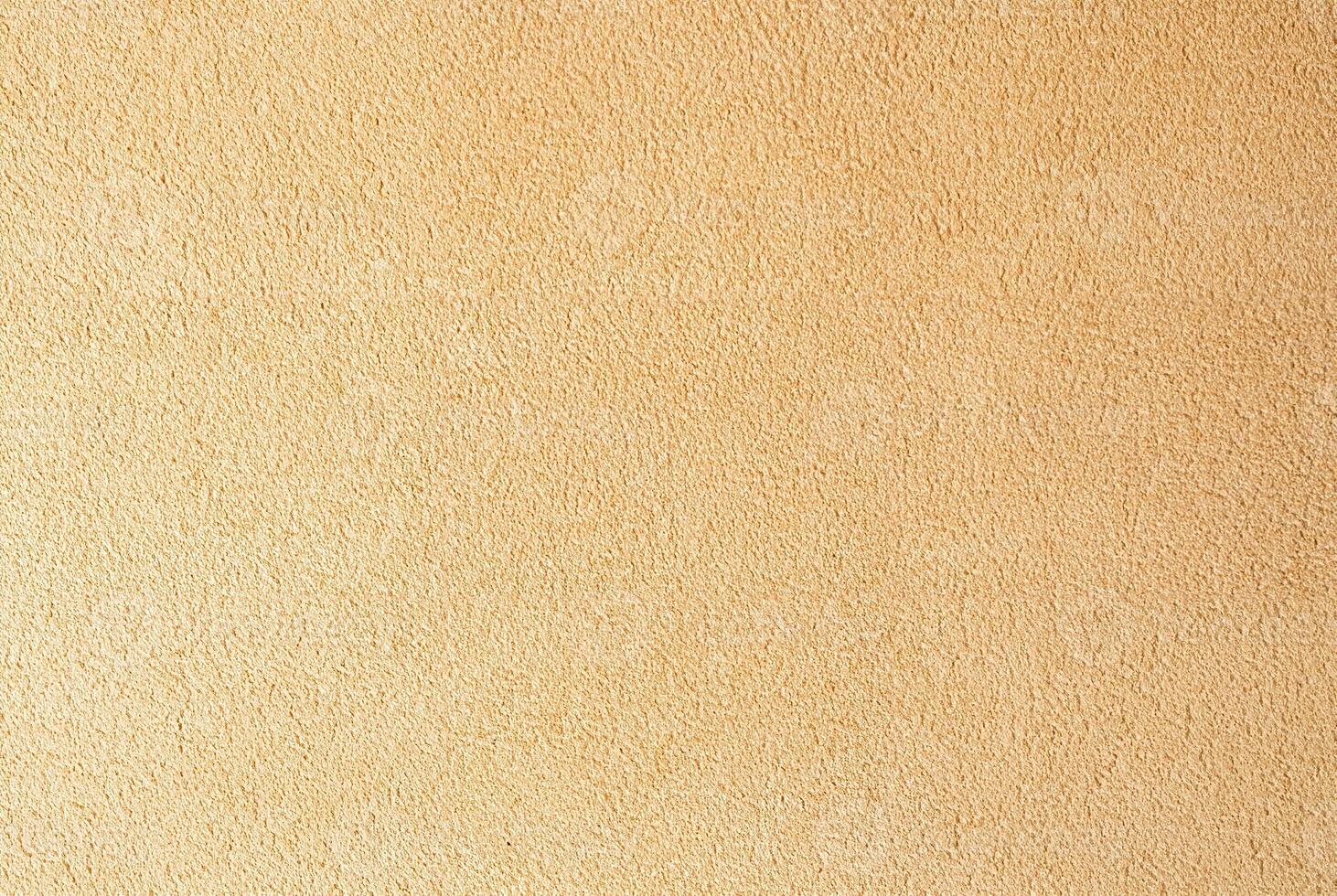 Beige textured wall surface close-up, ideal for use in backgrounds, interior design, and construction projects. photo