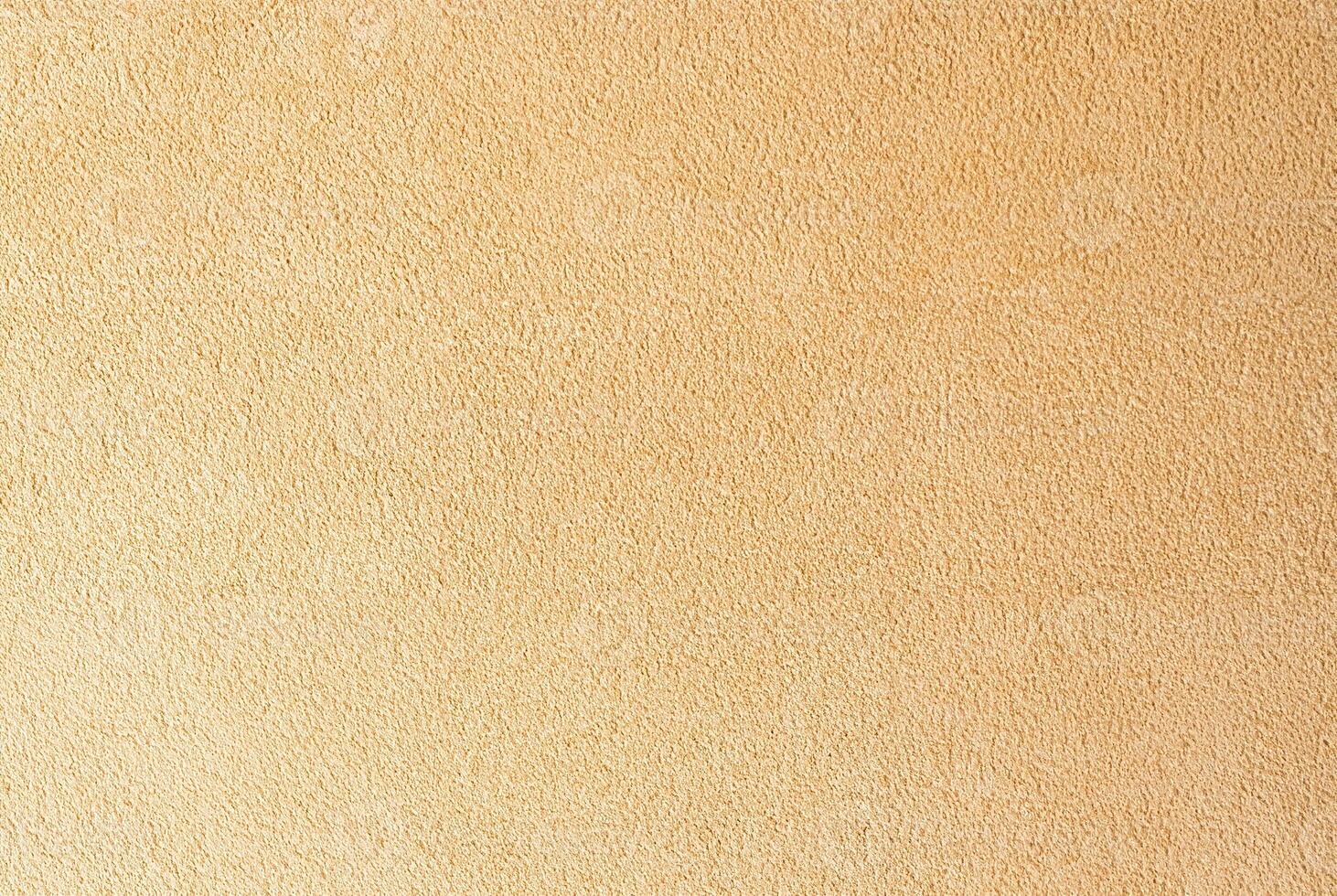 Beige textured wall surface close-up, ideal for use in backgrounds, interior design, and construction projects. photo