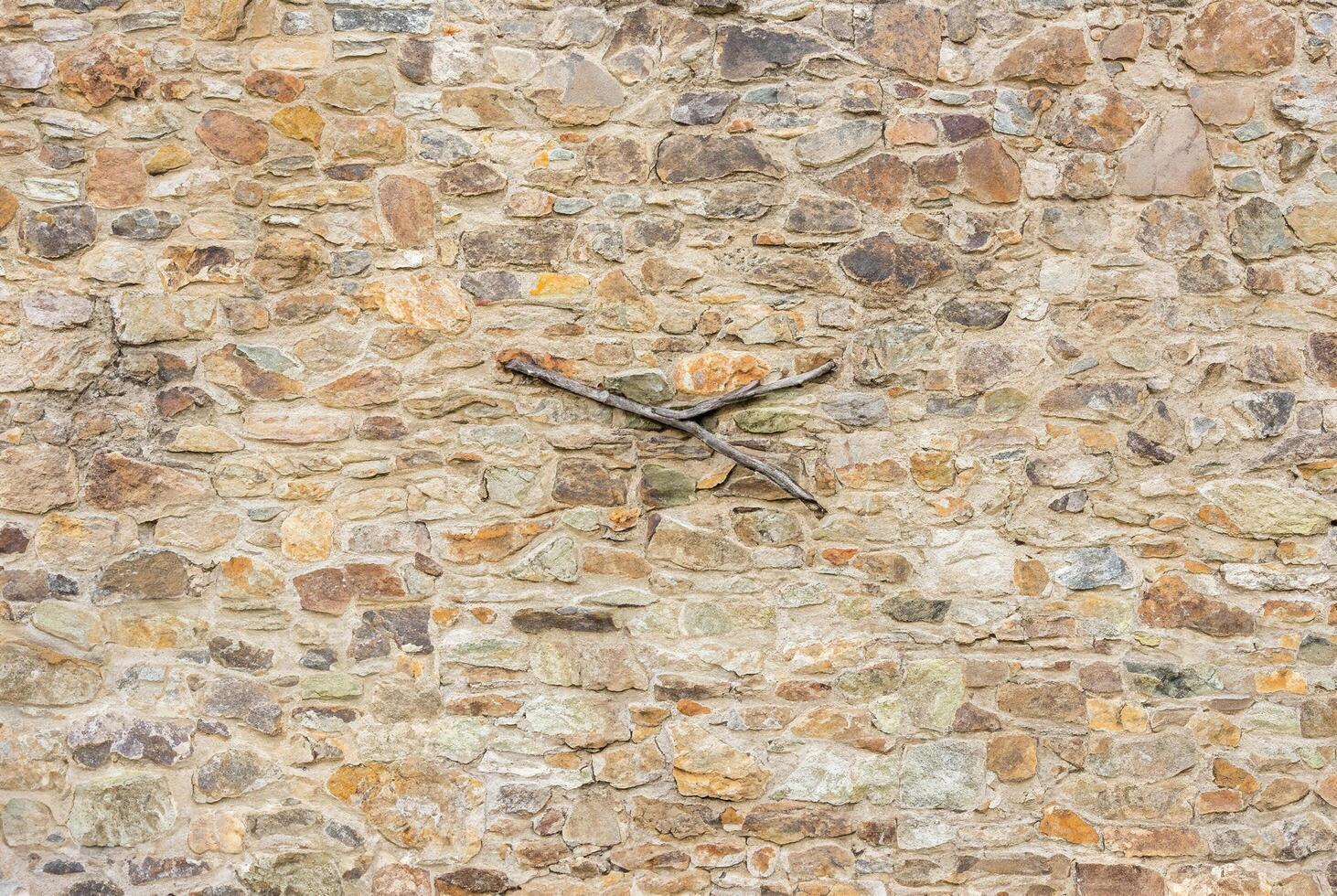 Close-up of a natural stone wall with rough texture and uneven stones, perfect for backgrounds. photo