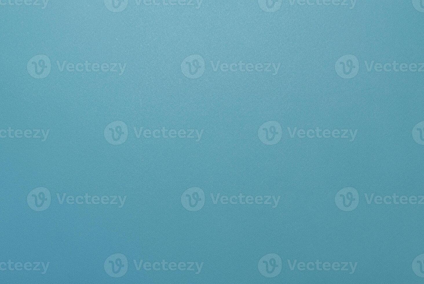 Simple minimalist blue textured background with a smooth surface, perfect for design projects. photo