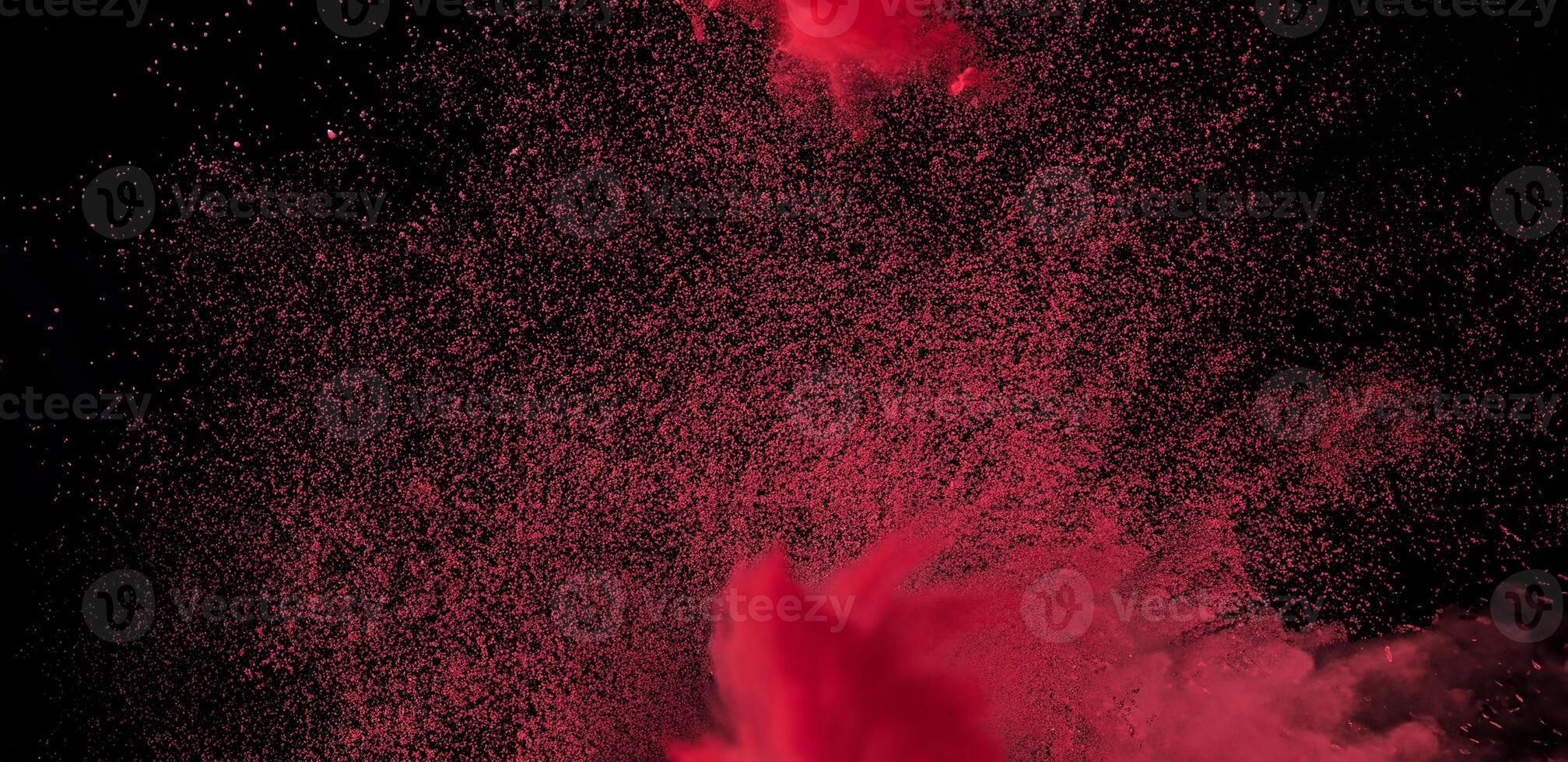 Close-up of abstract red powder explosion against a black background, ideal for creative or dynamic design projects. photo