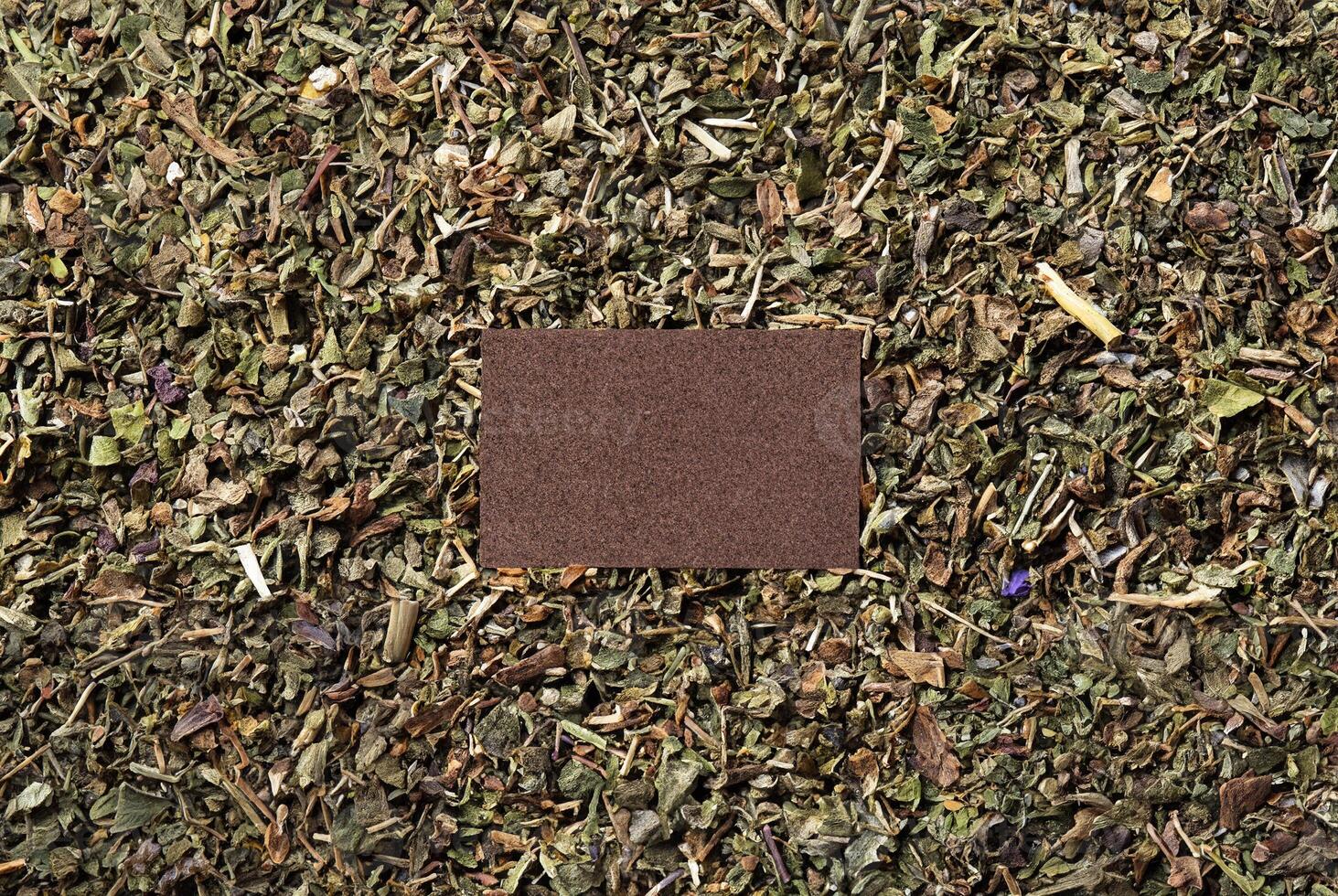 Close-up texture of dried herbal leaves scattered evenly, creating a natural, organic pattern. photo