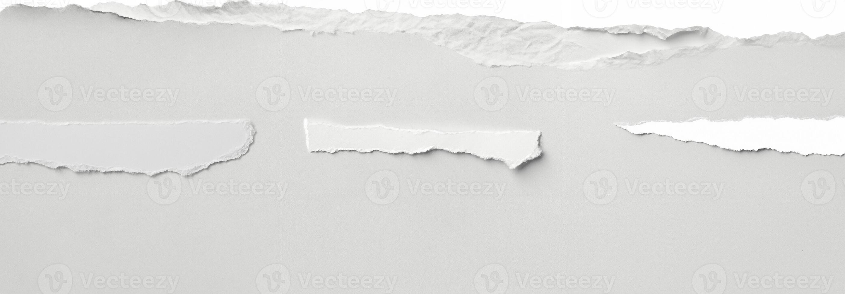 Clean torn edge of white paper against a plain background, ideal for creative, design, and crafting projects. photo