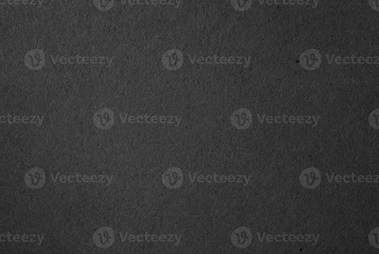 Close-up of dark textured black paper surface, ideal for backgrounds, textures, and minimalist design projects. photo