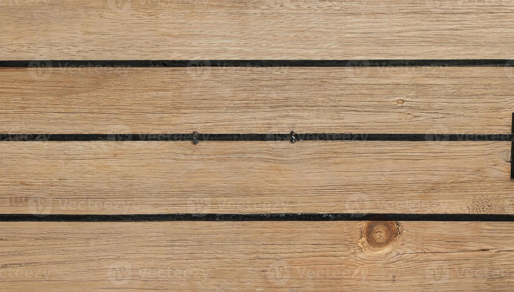 Close-up of wooden planks with dark grooves in a horizontal pattern, perfect for backgrounds, flooring, or architectural design. photo