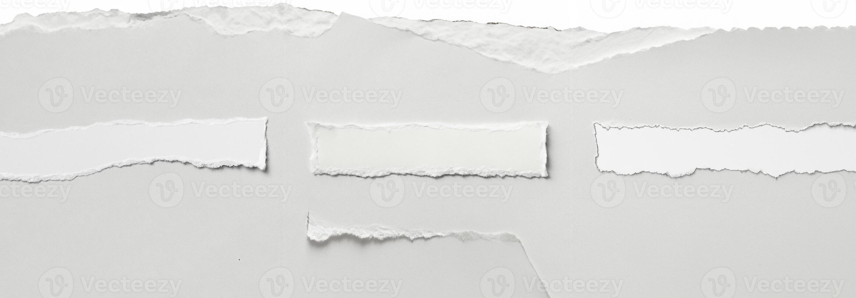Clean torn edge of white paper against a plain background, ideal for creative, design, and crafting projects. photo