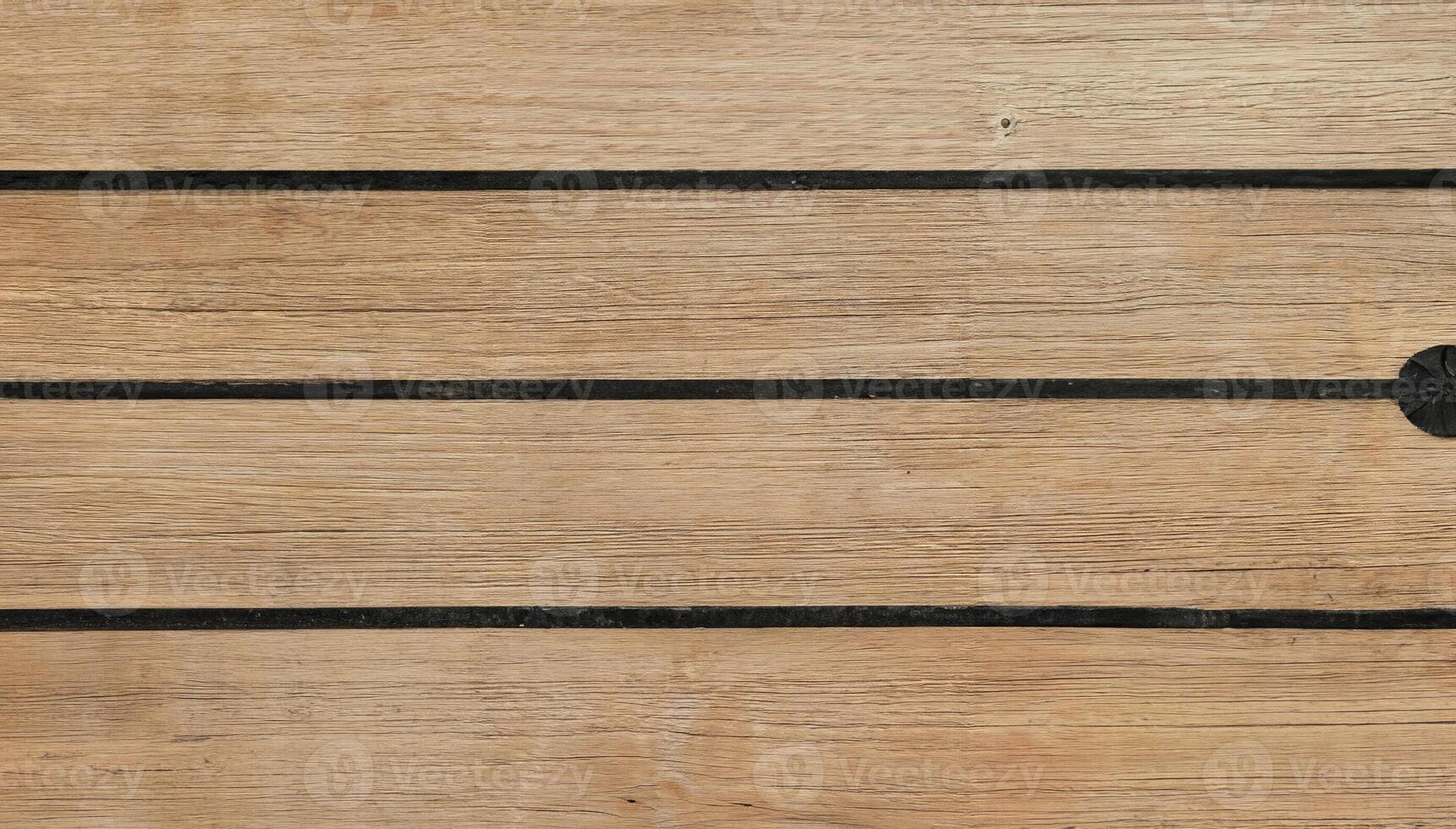 Close-up of wooden planks with dark grooves in a horizontal pattern, perfect for backgrounds, flooring, or architectural design. photo