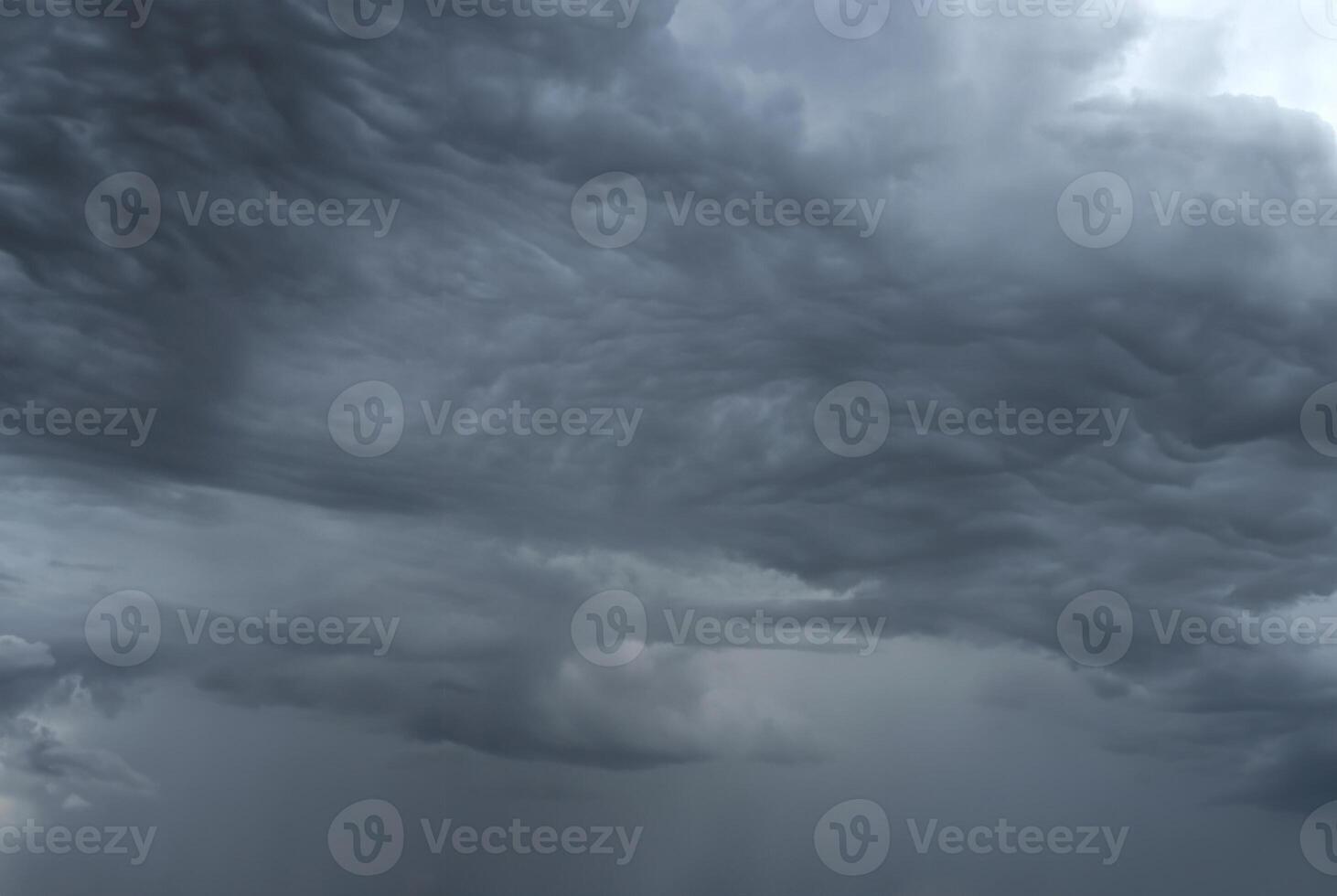 Dark, ominous storm clouds forming in the sky, signaling impending heavy rain. photo