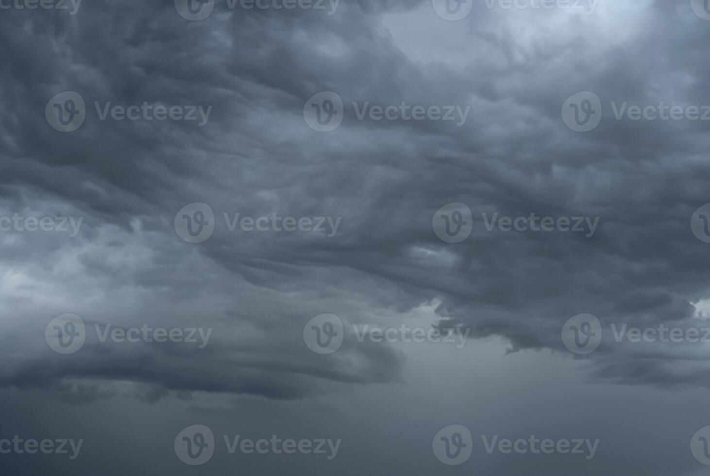Dark, ominous storm clouds forming in the sky, signaling impending heavy rain. photo