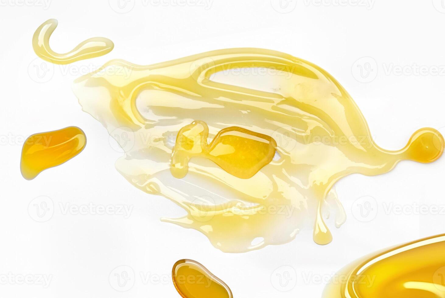 Close-up of a golden honey drizzle isolated on a white background. Smooth texture and glossy shine, perfect for food, cooking, and skincare concepts. photo