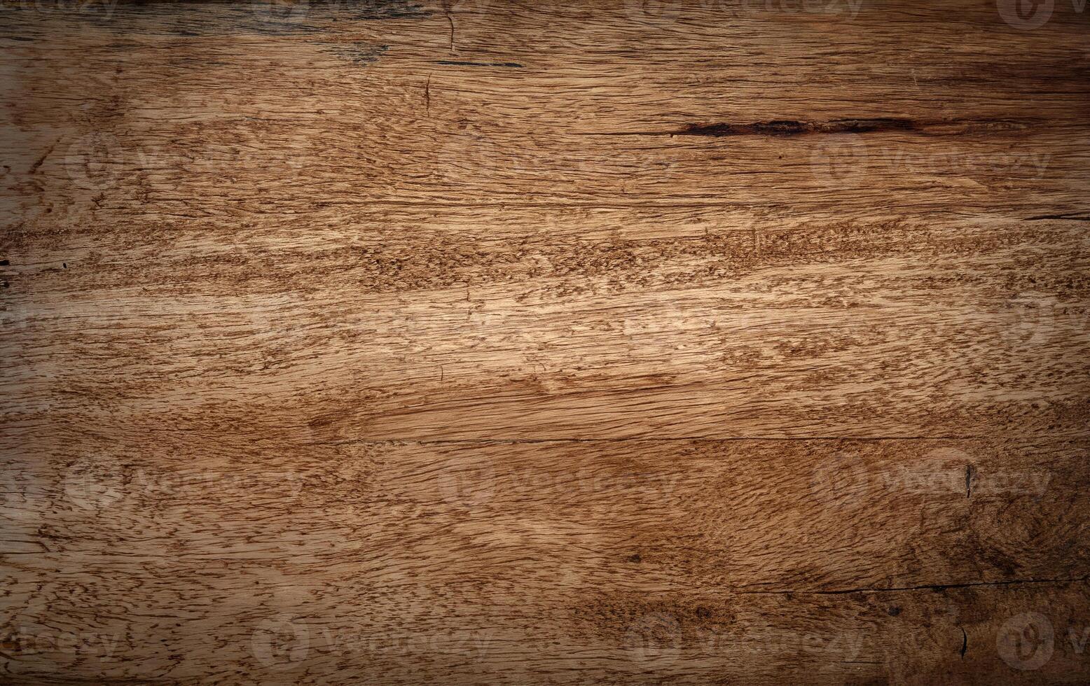 A close-up view of a natural wooden surface with rich grain patterns and slight imperfections, perfect for backgrounds, textures, or design projects. photo