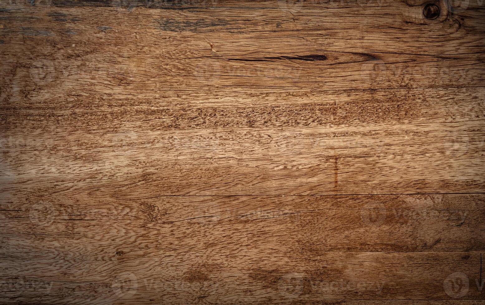 A close-up view of a natural wooden surface with rich grain patterns and slight imperfections, perfect for backgrounds, textures, or design projects. photo