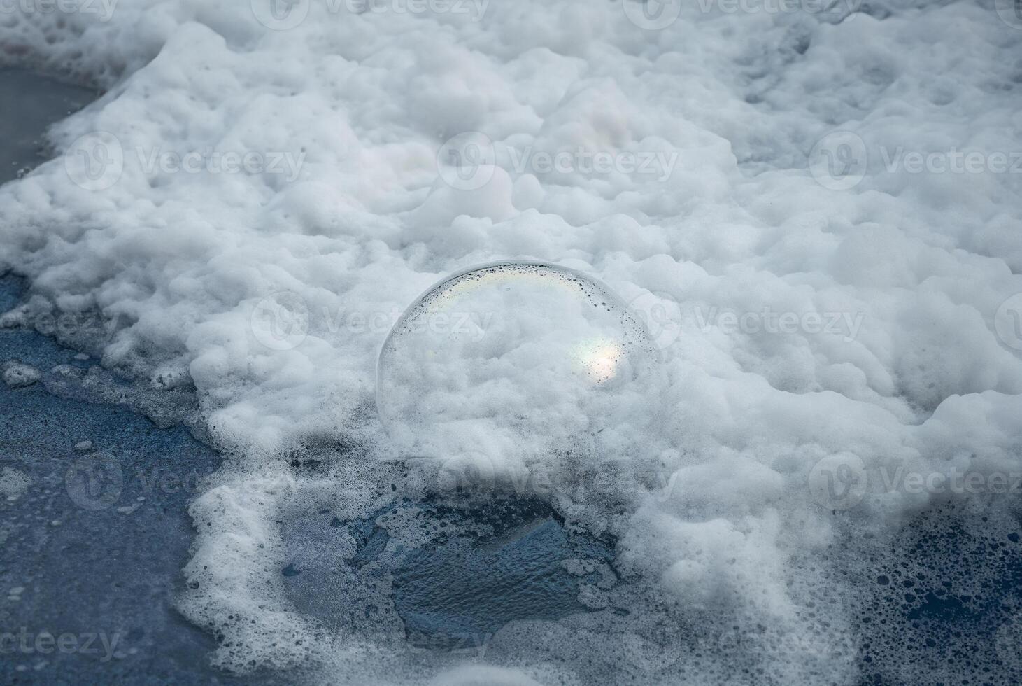 Close-up of white foam and bubbles floating on water surface, perfect for backgrounds, texture, or environmental concepts. photo