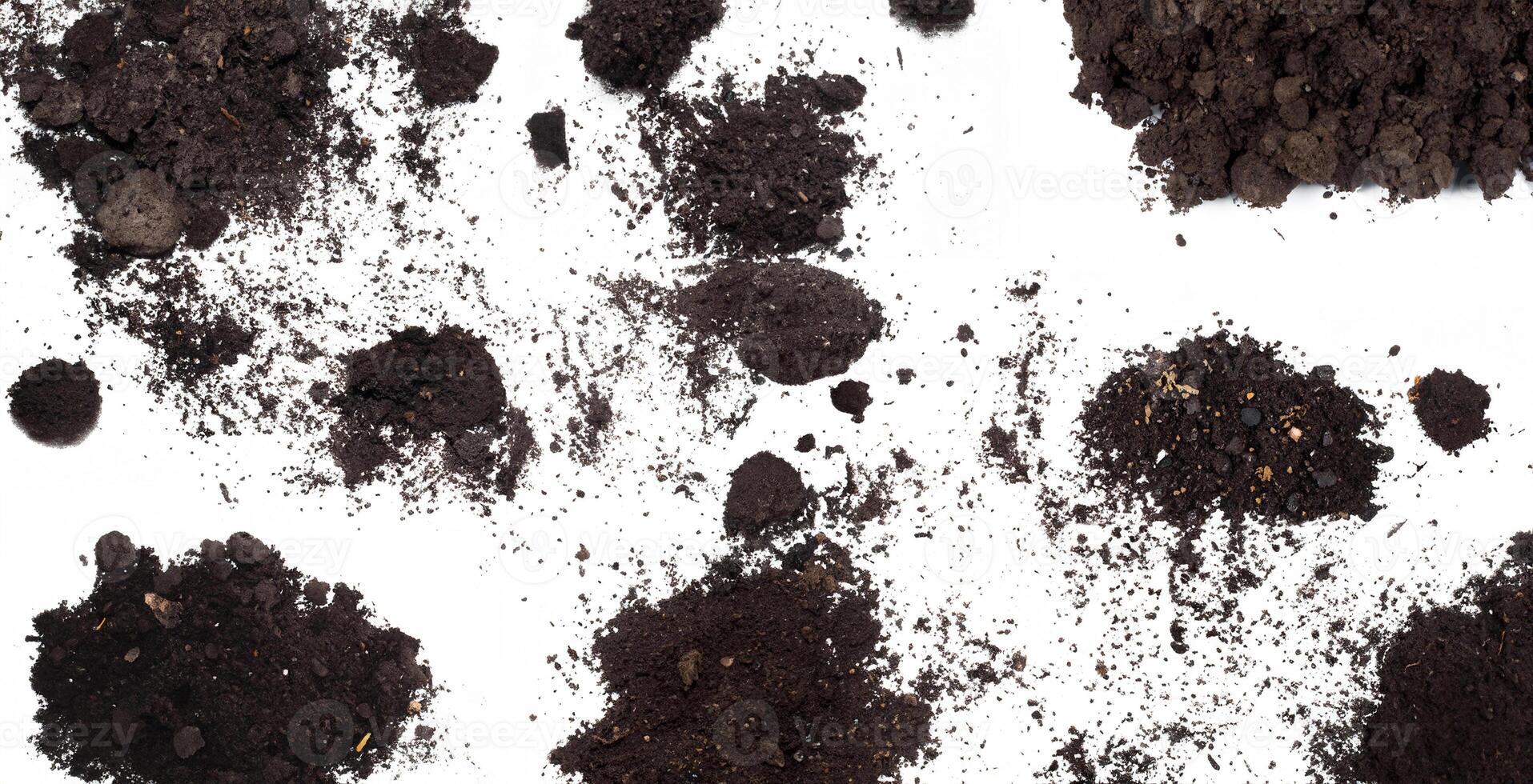 Scattered dirt and soil clumps on a clean white background, ideal for textures, backgrounds, or gardening themes. photo