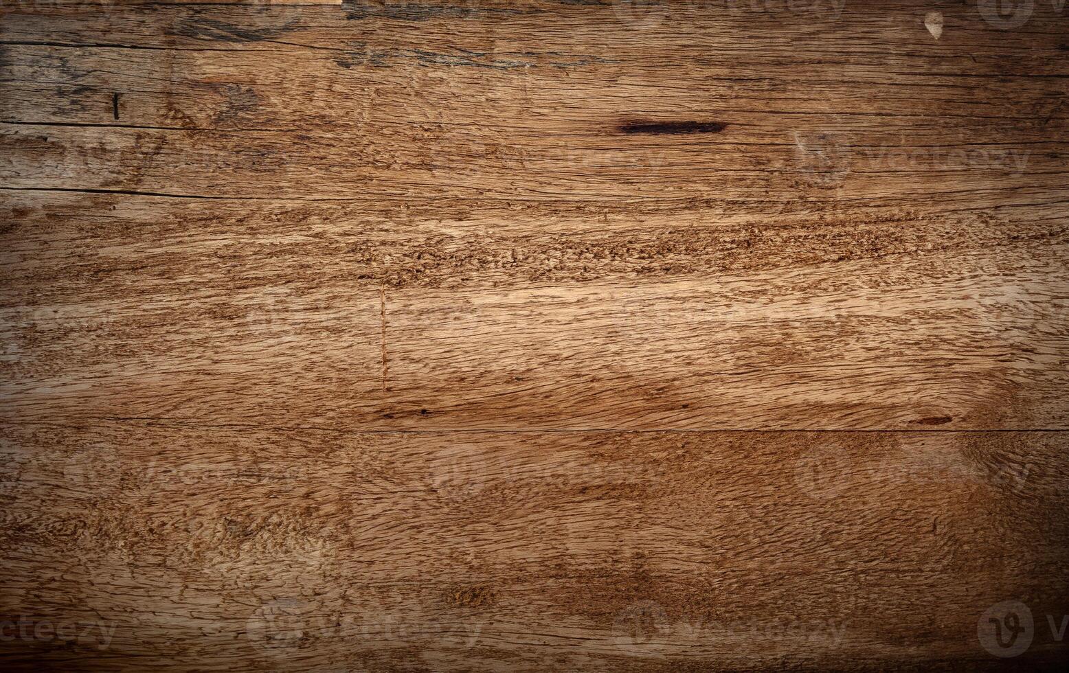 A close-up view of a natural wooden surface with rich grain patterns and slight imperfections, perfect for backgrounds, textures, or design projects. photo