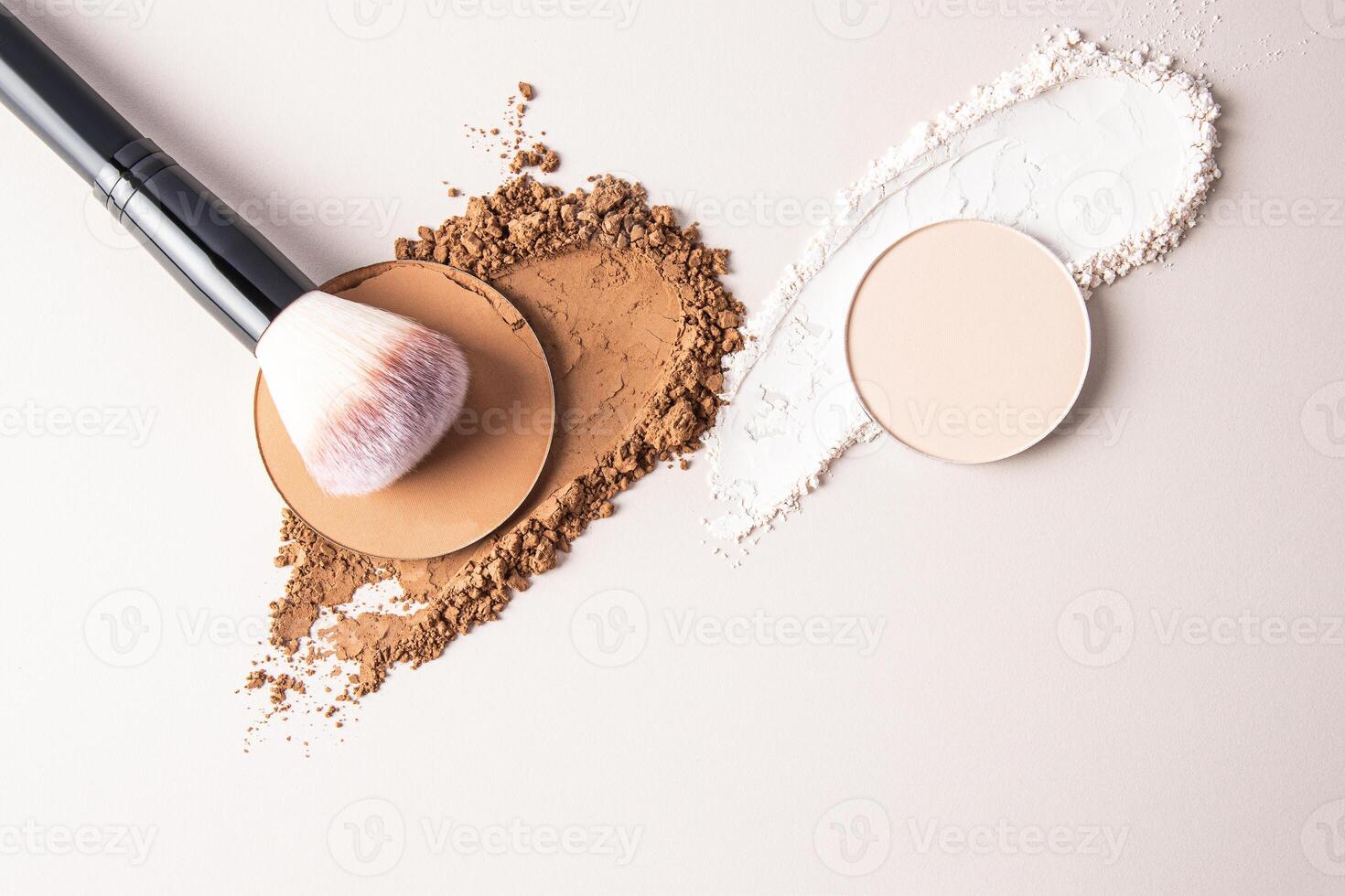 A sample of a round block of compact powder in a brown tone and a chic brush for applying makeup. loose powder sample. top view. layout for design photo