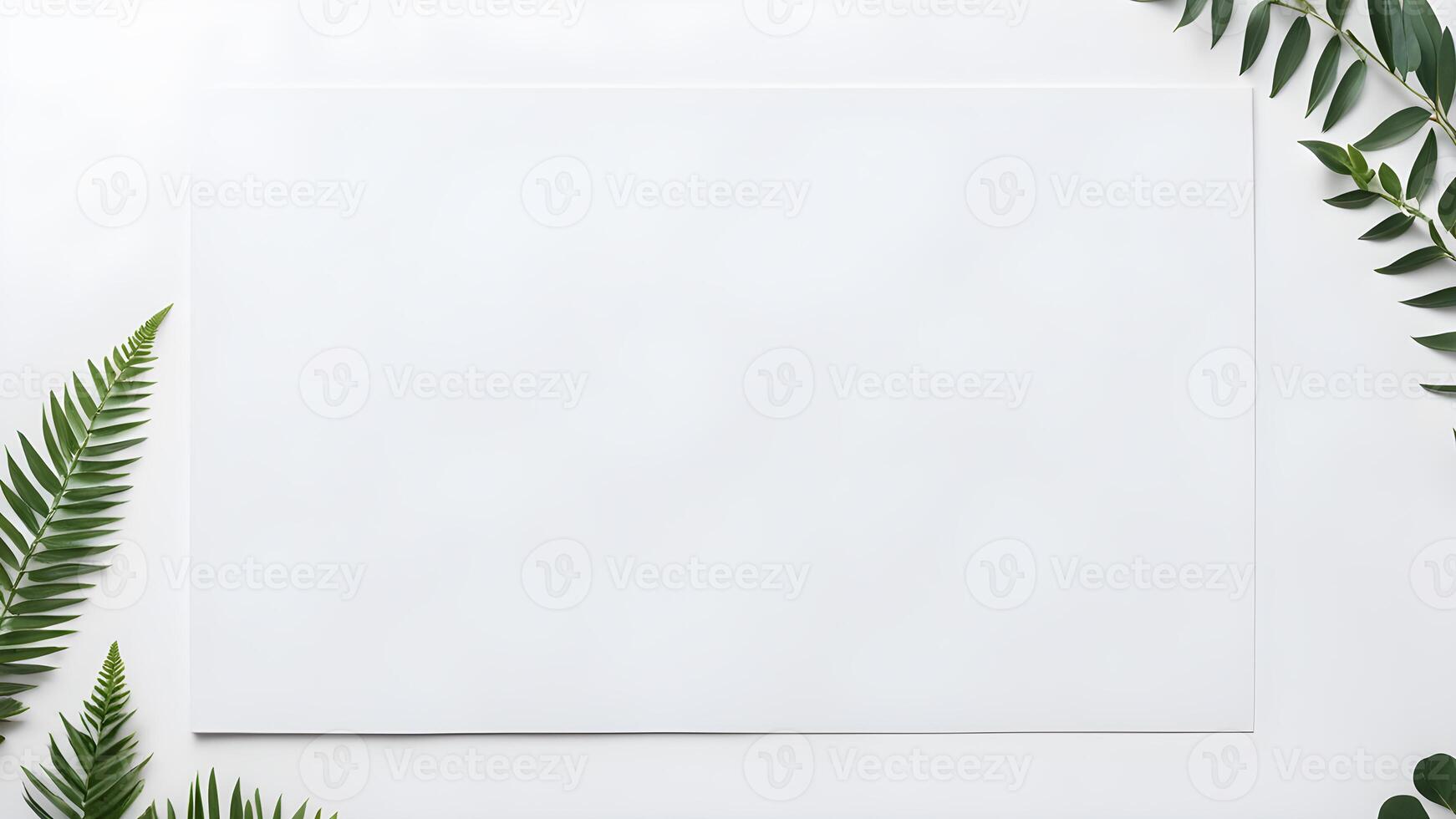 Top view blank space white rectangle paper mock up adorned by tropical plant leaf on white table for creative design photo