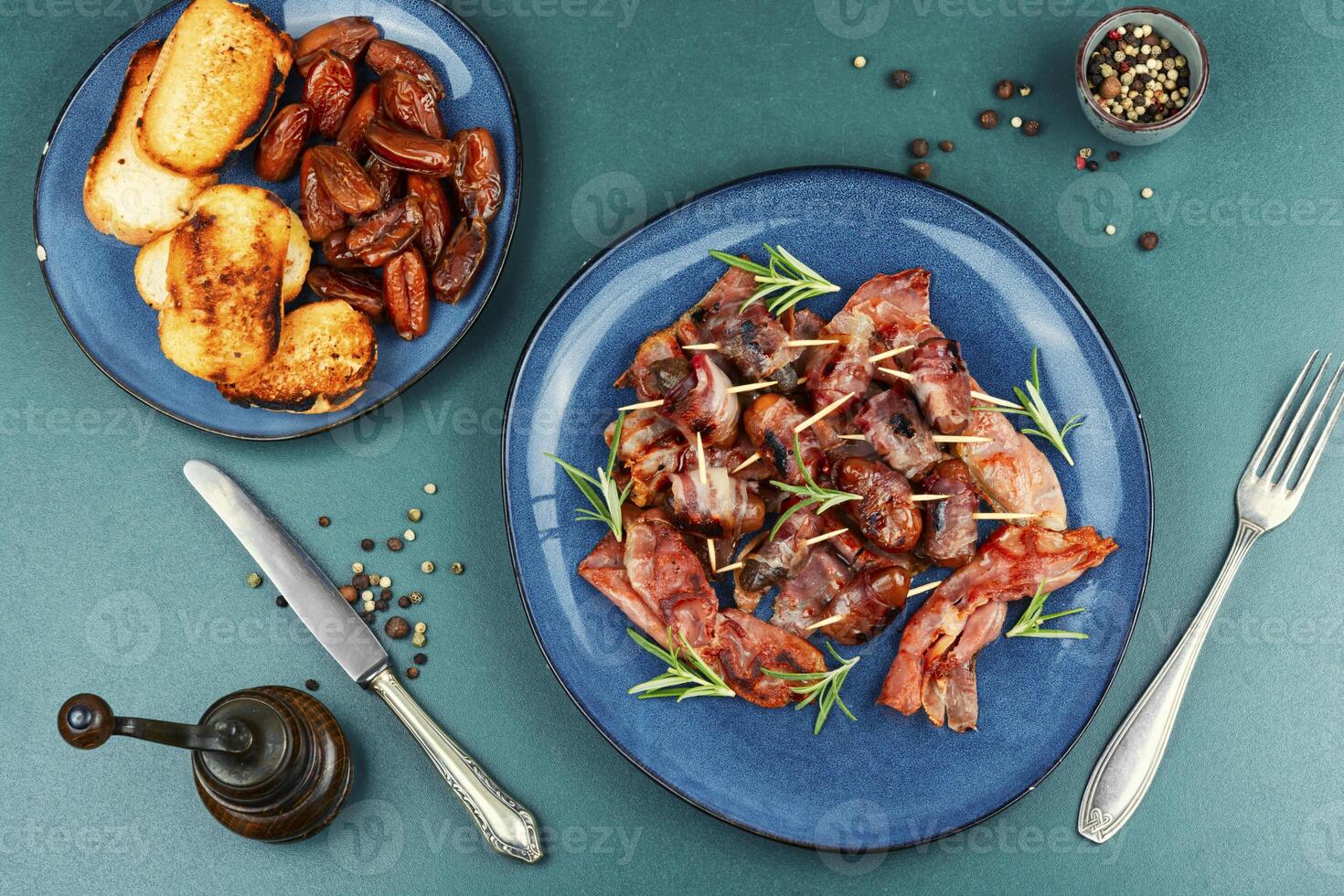 A plate of bacon wrapped dates. photo