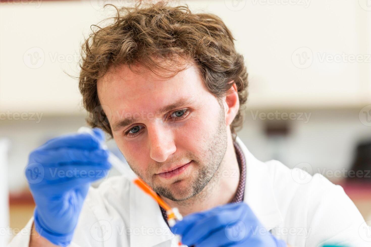 Young scientist in a research laboratory creating a scientific experiment, laboratory concept photo