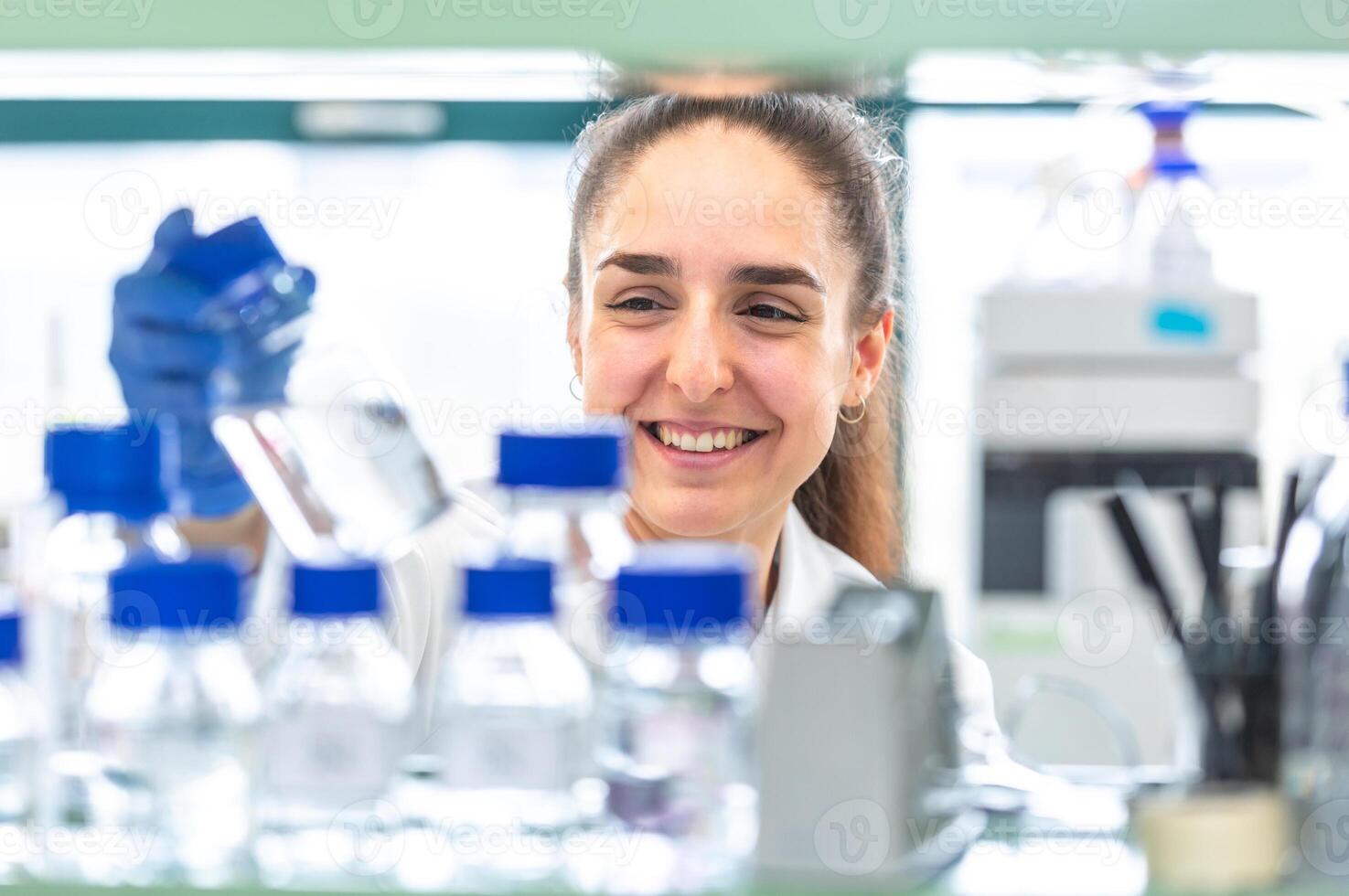 Young woman scientist holding test tube with a lab glassware, science laboratory research and development concept, laboratory research photo