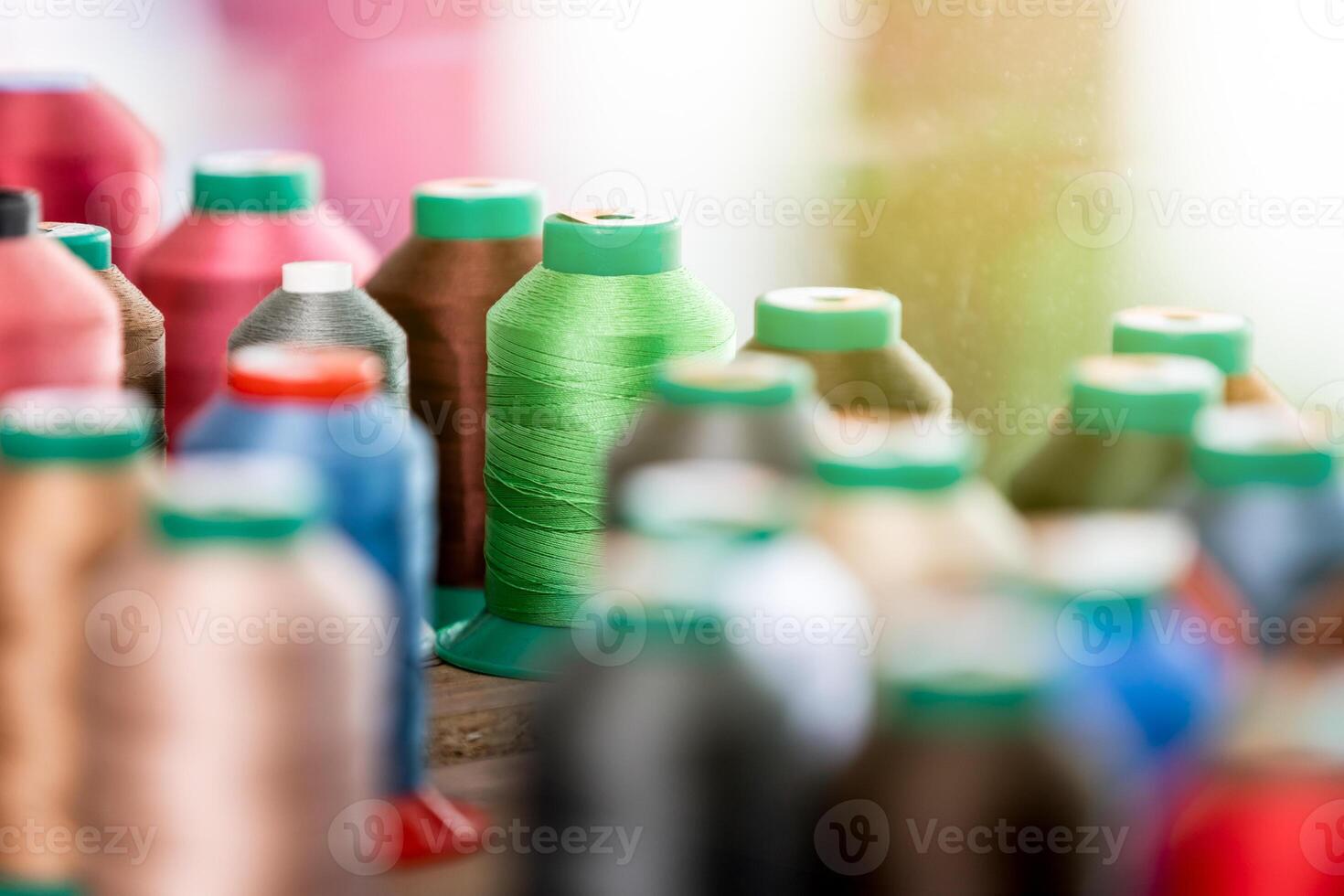 Close up of colorful threads in the leatherworking or tailoring studio photo