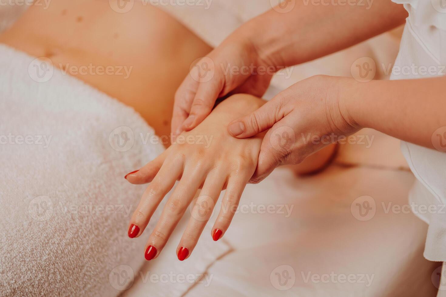 Beautician massaging hand of female in the spa salon, lifestyle and healthcare concept photo