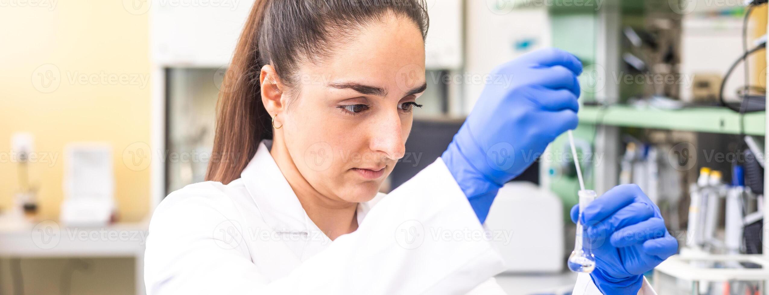 Young woman scientist in a research laboratory creating a scientific experiment, laboratory concept photo