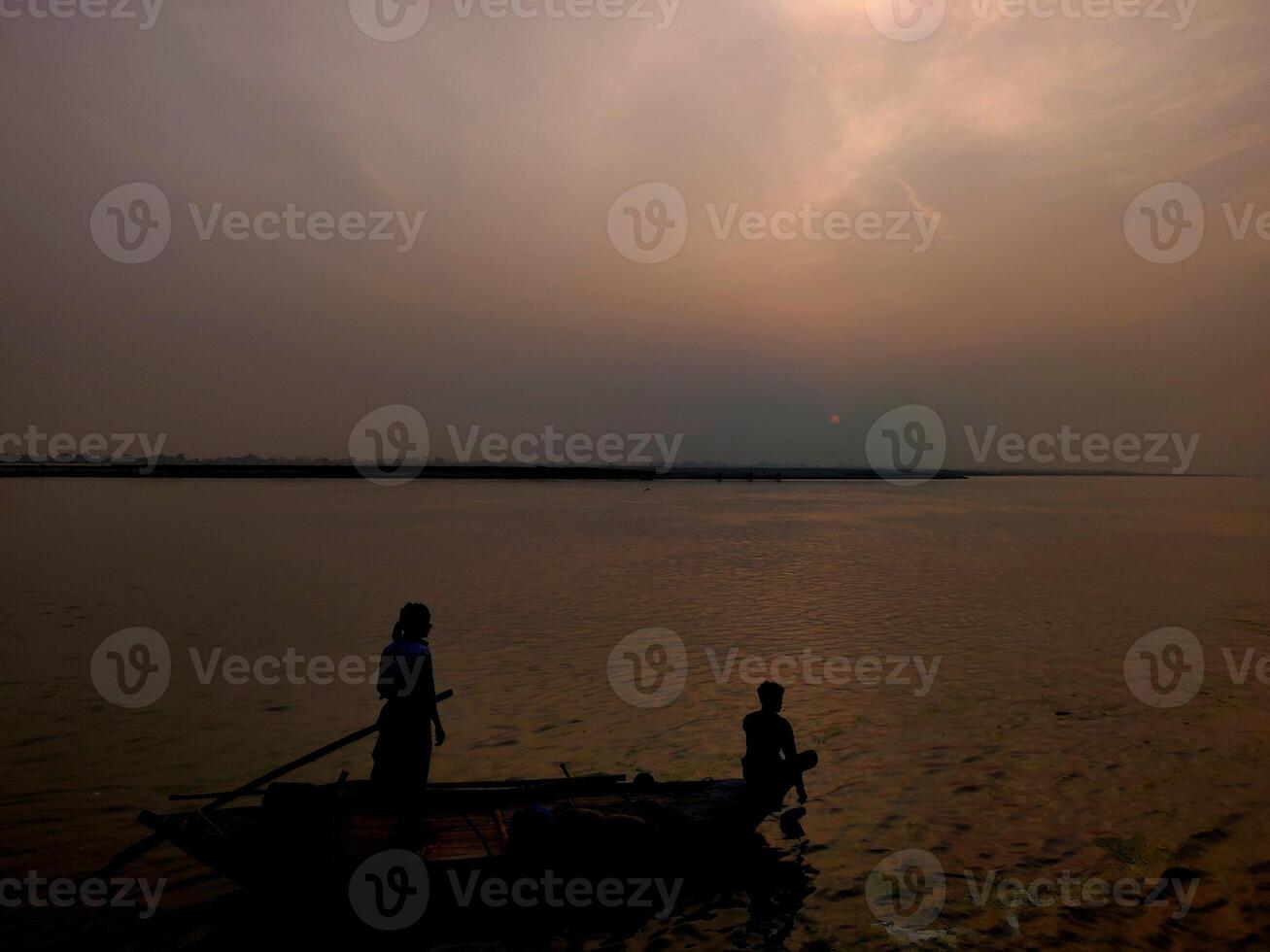 People fishing on a boat during dawn time photo