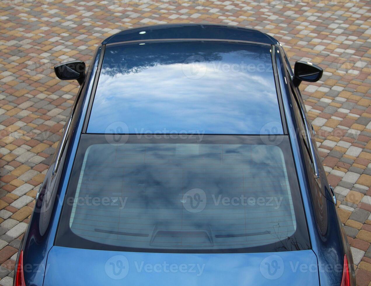 Ongoing View From Above On The Roof Of Blue Car photo