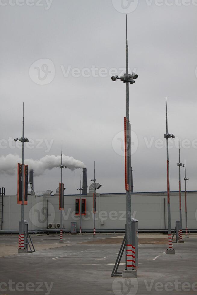 Parking Zones On A Rooftop Car Parking With Industrial Background photo
