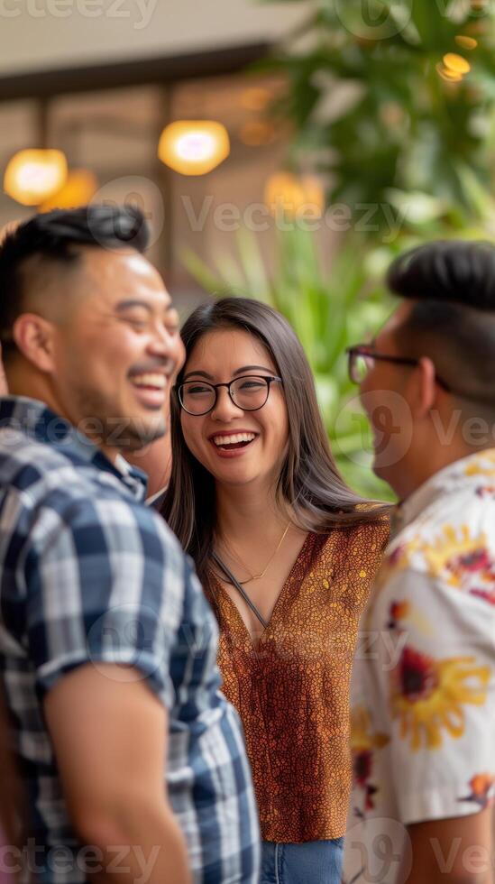 A group of four people from different backgrounds, smiling and chatting, with a community center softly blurred in the background photo