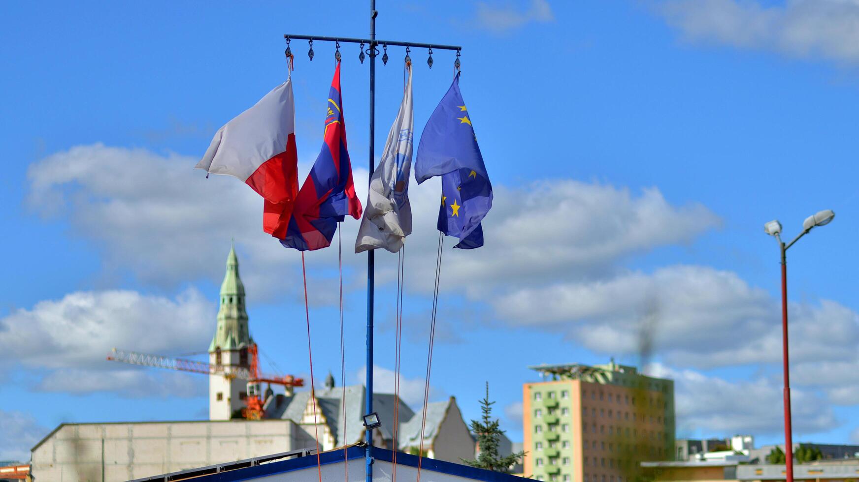 Szczecin, Poland. 14 September 2024. The flags of Poland, Szczecin, WOPR and the European Union waving against the blue sky photo